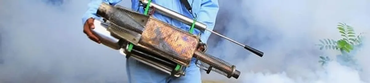 Fumigation technician using a fogger for deep pest treatment in Bradenton, FL