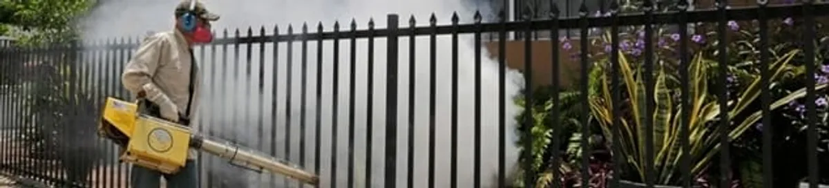 Mosquito control technician fogging a yard perimeter for mosquito reduction in Bradenton, FL